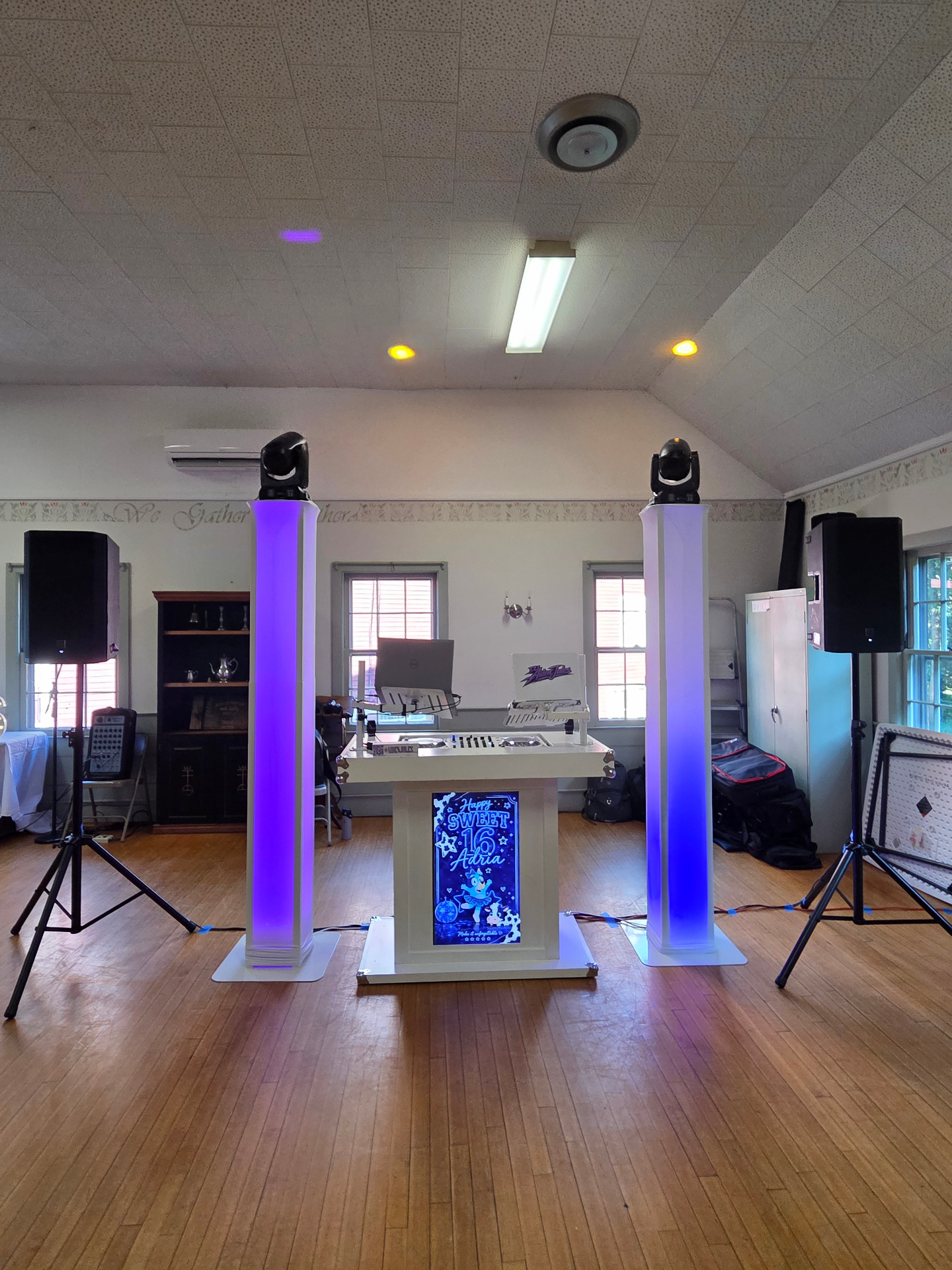 DJ booth and lighting towers prepared for a Sweet 16 before the event begins
