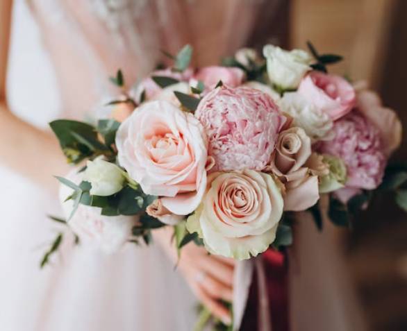 Bridal bouquet of soft pink and cream roses with peonies and eucalyptus